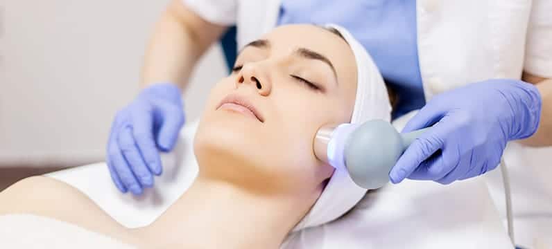 woman undergoing cosmetic dermatology treatment on her face in south miami, fl