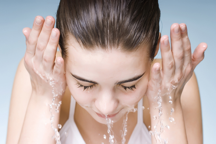 Woman washing her face